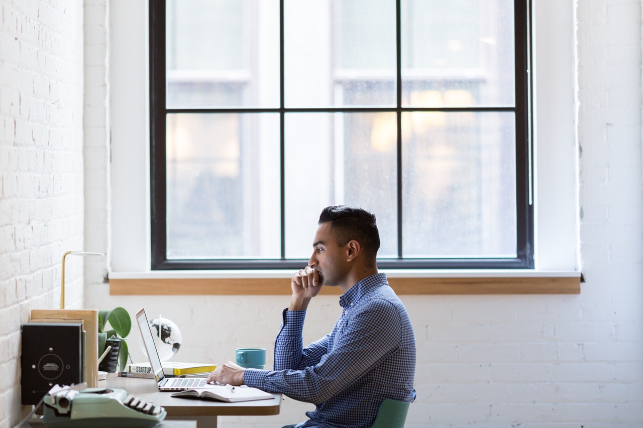 Man viewing sextortion email